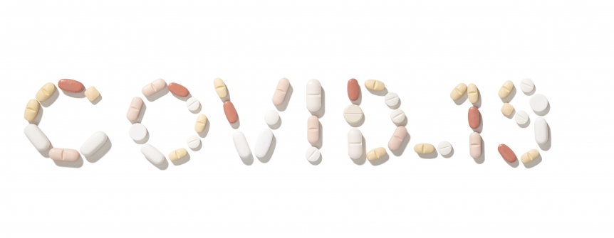 Covid-19 written with pills isolated on white background
